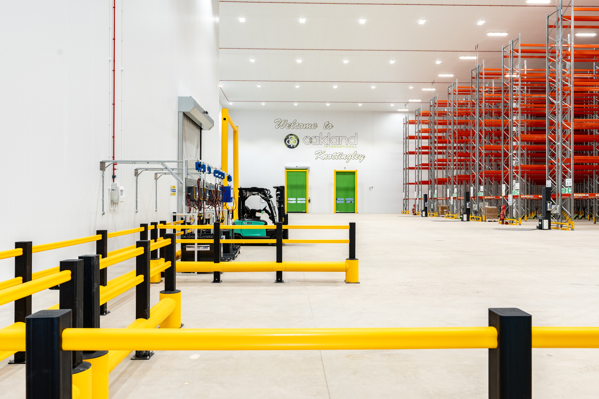 Distribution warehouse interior with safety barriers and racking